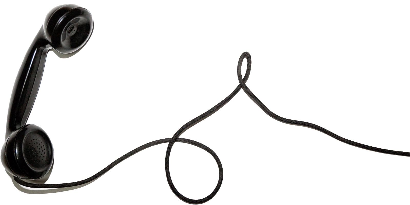 A photo of a retro phone handset receiver handle with cord.