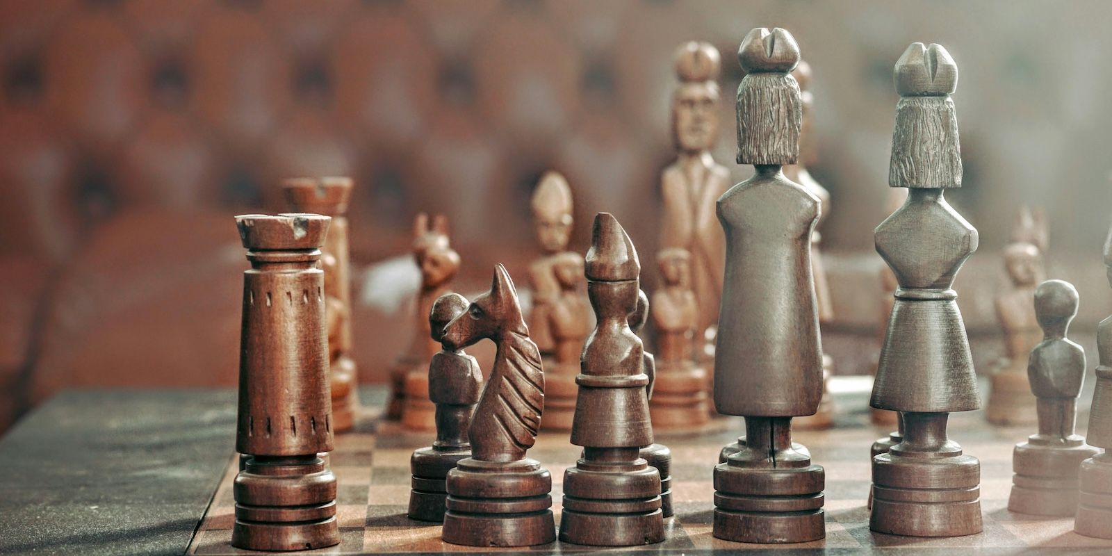 A photo of a chessboard with wooden chess pieces.